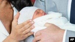 Britain's Prince Harry and Meghan, Duchess of Sussex, during a photocall with their newborn son, in St George's Hall at Windsor Castle, Windsor, south England, May 8, 2019.