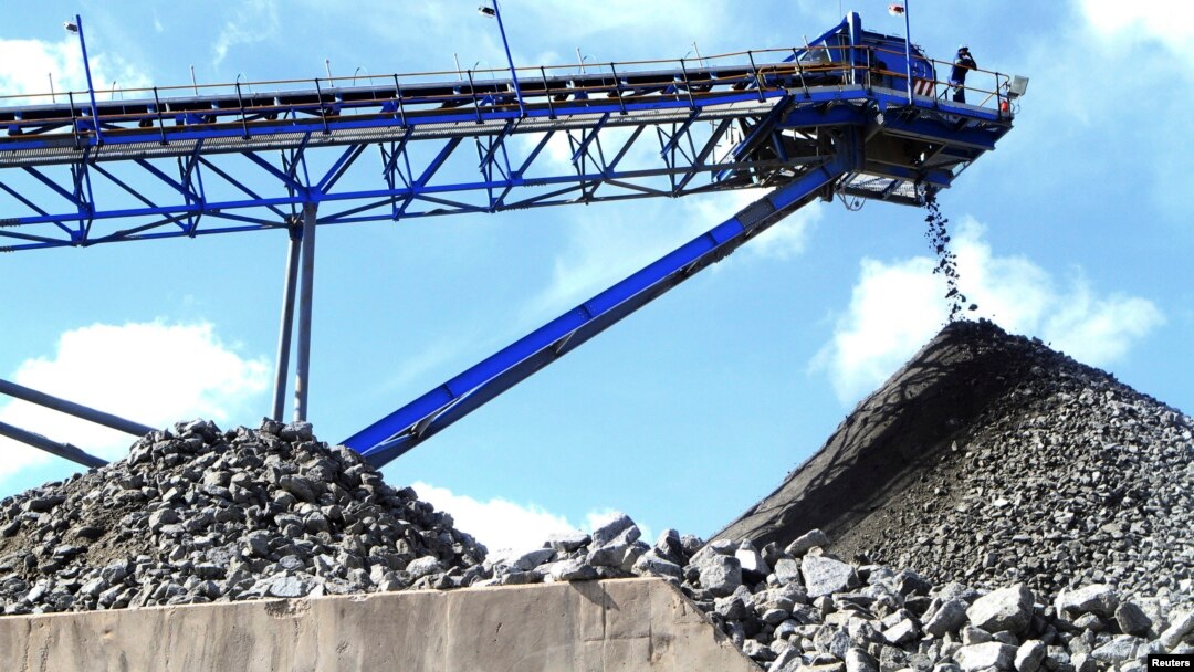 FILE - A conveyor belt carries ore extracted at Mimosa Platinum mine about 400km (249 miles) south of the capital Harare, Zimbabwe, Feb. 16, 2012.