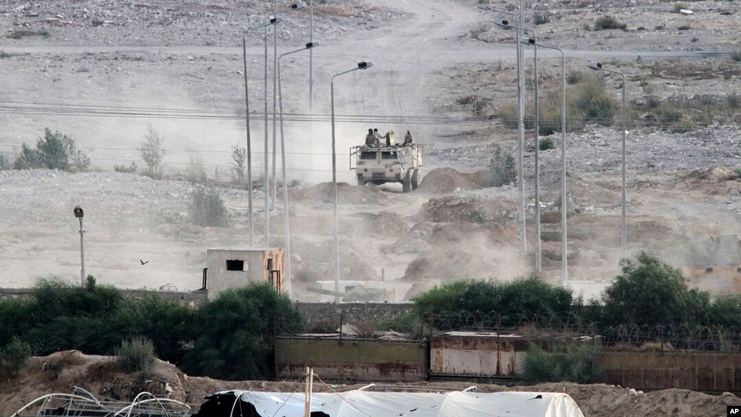 Egyptian soldiers sit atop a military personnel carrier securing the Egyptian side of the border between Egypt and Rafah in the southern Gaza Strip, July 1, 2015. 