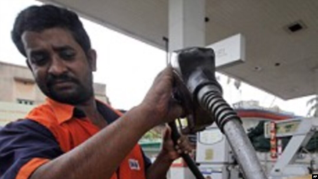 FILE - Man fills up with diesel at a fuel station in Kolkata.
