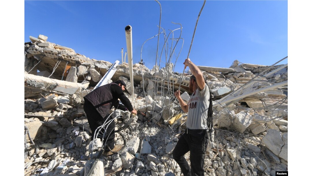 People look for survivors in the ruins of a destroyed Medecins Sans Frontieres (MSF) supported hospital hit by missiles in Marat Numan, Idlib province, Syria, February 16, 2016.