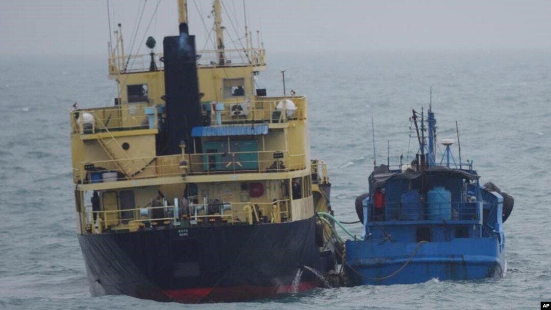 FILE - This Japanese Ministry of Defense photo shows what it says is the North Korean-flagged tanker Yu Jong 2, left, and the Min Ning De You 078 in the East China Sea, Feb. 16, 2018. Concern had been expressed about a goods transfer that could have violated U.N. sanctions on North Korea. The U.N. Security Council on March 30, 2018, blacklisted 27 ships, 21 companies and a businessman for helping North Korea evade sanctions.
