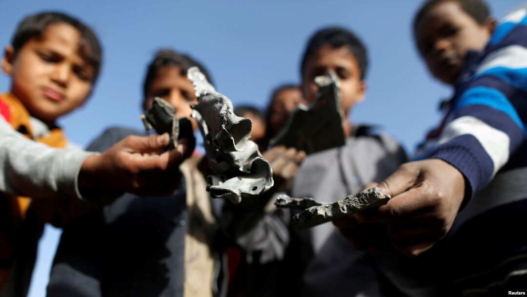 Boys hold missile shrapnel they collected from the site of a Saudi-led air strike in the Houthi-held capital Sanaa, Yemen, Jan. 20, 2019.