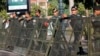 FILE - Riot police stand guard at a blocked street outside the Supreme Court in Phnom Penh, Cambodia, Nov. 16, 2017.
