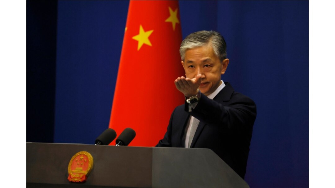 FILE - Foreign Ministry spokesperson Wang Wenbin gestures for questions during the daily briefing in Beijing, July 23, 2020.