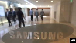 FILE - The corporate logo of Samsung Electronics Co. is seen at its shop in Seoul, South Korea.