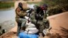 Malian soldiers man a bridge at the entrance of Gao, where a suicide bomber attacked a checkpoint, Feb. 8, 2013.
