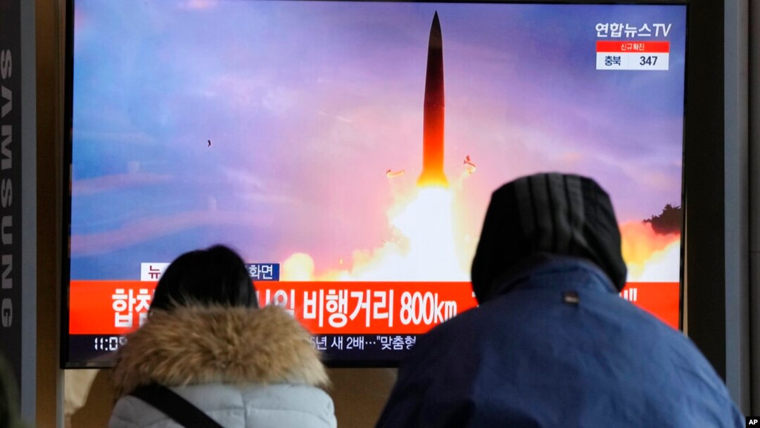 People watch a TV showing a file image of North Korea's missile launch during a news program at the Seoul Railway Station in Seoul, South Korea, Jan. 30, 2022.