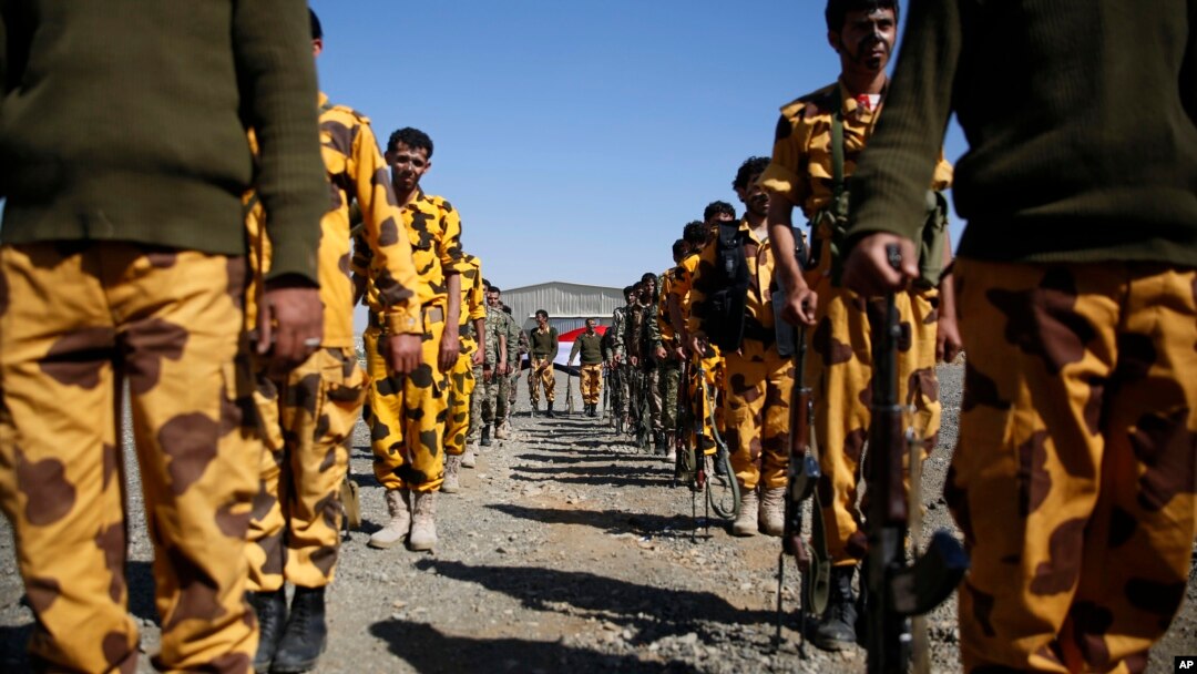 Shi'ite fighters, known as Houthis, stand at attention as they parade during a tribal gathering showing support for the Houthi movement in Sana'a, Yemen, Monday, Dec. 14, 2015.
