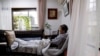 FILE - Yasuda Toyoko (95), who has stomach cancer and dementia, watches television in the living room of her daughter's house in Tokyo, Japan, Sept.r 6, 2017.