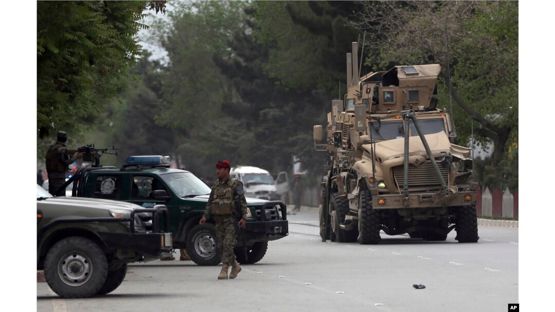 A damaged US military vehicle is being pulled near the site of a suicide attack in Kabul, Afghanistan, May 3 , 2017. Afghan officials say that at least four people have been killed in a suicide car bomb attack in the capital Kabul.