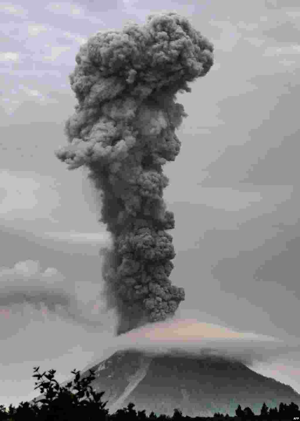 Mount Sinabung volcano spews thick volcanic ash, as seen from the town of Brastagi in Karo, North Sumatra province, Indonesia.