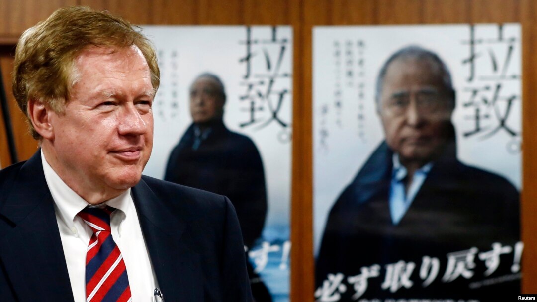Robert King, U.S. special envoy for North Korean human rights issues, stands in front of campaign posters of Japan's abduction issue during a meeting with Japan's Minister-in-Charge of the Abduction Issue and head of the national public safety commission Keiji Furuya (not in picture) in Tokyo August 28, 2013. 