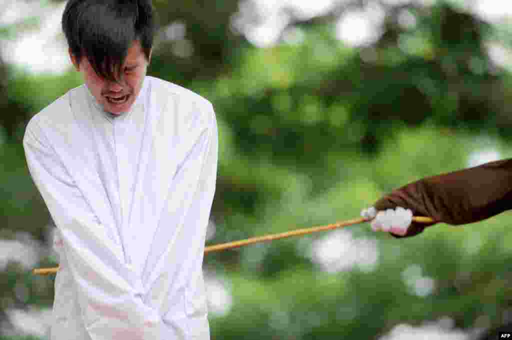 One of two men is publicly caned for having sex, in a first for the Muslim-majority country where there are concerns over mounting hostility towards the small gay community, in Banda Aceh, Indonesia. The pair, aged 20 and 23, were found guilty of having broken sharia rules in conservative Aceh province -- the only part of Indonesia that implements Islamic law -- and sentenced to 85 strokes of the cane each.