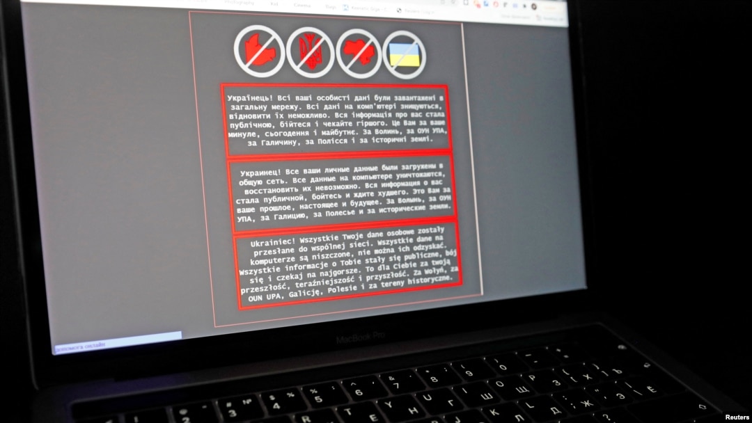 FILE - A laptop screen displays a warning message in Ukrainian, Russian and Polish that appeared on the official website of the Ukrainian Foreign Ministry after a massive cyberattack, Jan. 14, 2022. 