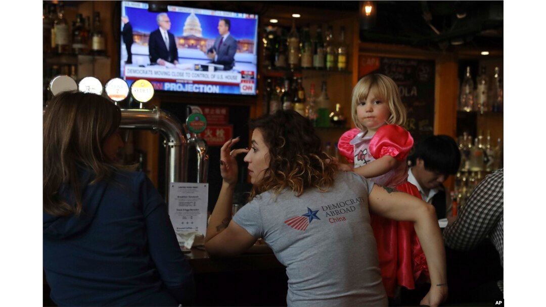 Christine Fox and her daughter Emmylou Fox from Washington state wait for the results of the U.S. midterm elections during a gathering organized by Democrats Abroad in Beijing, China, Nov. 7, 2018.