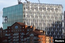 FILE - The new U.S. Embassy catches the evening light as it nears completion, in Nine Elms, London, Oct. 20, 2017.