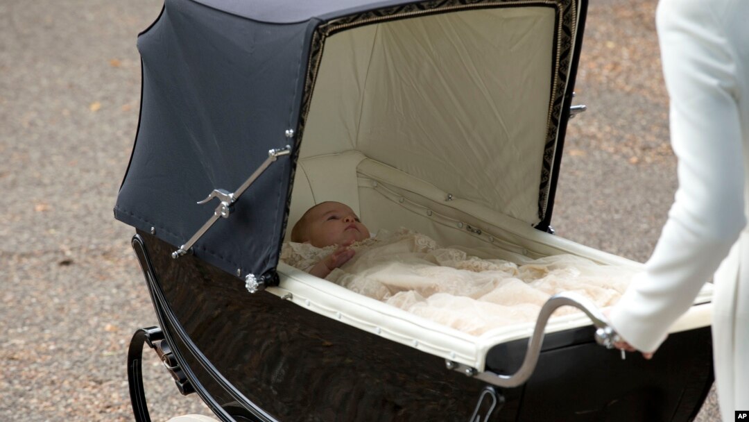 Britain's Princess Charlotte is pushed in a pram by her mother Kate the Duchess of Cambridge as they arrive for Charlotte's Christening at St. Mary Magdalene Church in Sandringham, England, July 5, 2015. 