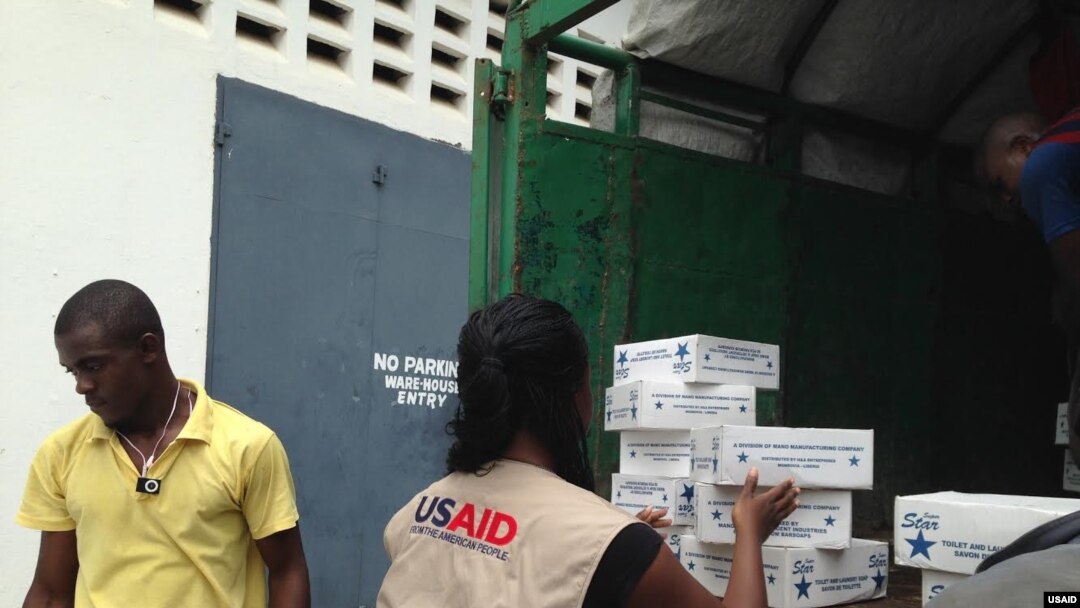 Members of the USAID-led Disaster Assistance Response Team (DART) procure and unload urgent Ebola relief supplies and hygiene items in Monrovia, Liberia, on Aug. 27, 2014.