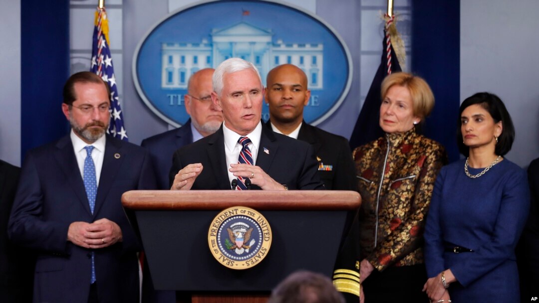 FILE - Vice President Mike Pence, flanked by administration officials, including Health and Human Services Secretary Alex Azar (L), speaks about the coronavirus outbreak, in the briefing room of the White House in Washington, March, 9, 2020.