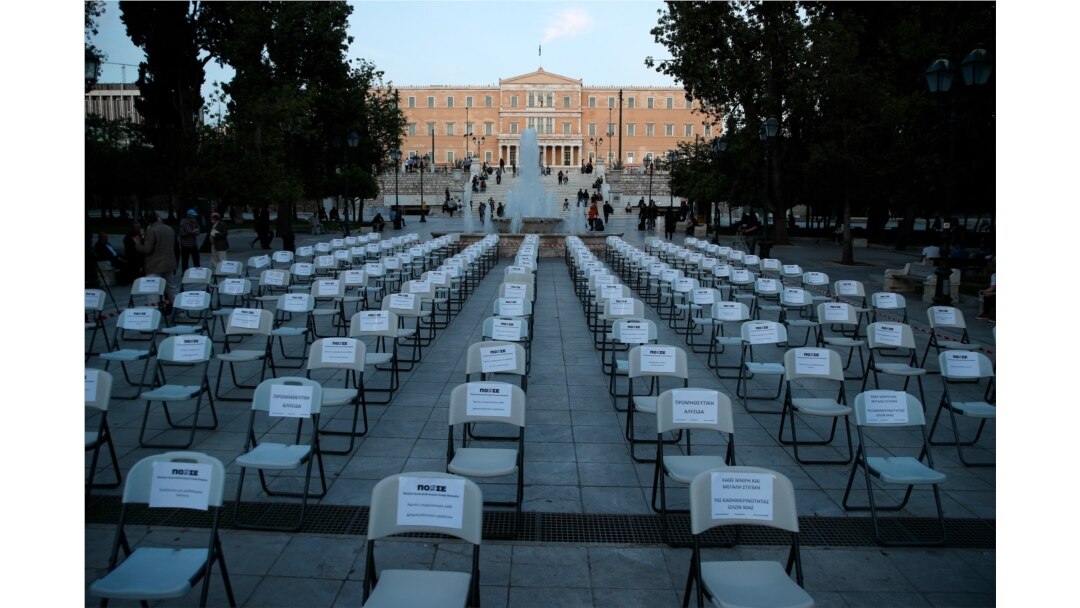 Empty chairs with various slogans from the union of bars and restaurants owners are placed at Athens' main Syntagma square May 6, 2020.