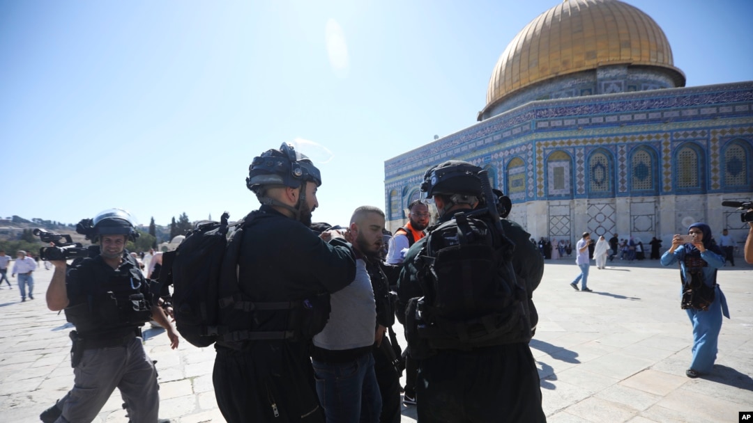 Israeli police arrests a Palestinian worshipper at al-Aqsa mosque compound in Jerusalem, Aug. 11, 2019.