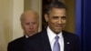 President Barack Obama smiles as he arrives with Vice President Joe Biden to make a statement regarding the passage of the fiscal cliff bill in the Brady Press Briefing Room at the White House in Washington, Janaury 1, 2013.