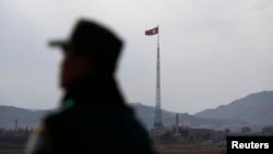 FILE - A North Korean flag flutters on top of a tower at the propaganda village of Gijungdong in North Korea, in this picture taken near the truce village of Panmunjom. New reviews of satellite images suggest Pyongyang may possess another missile launching site at a village once suspected of housing nuclear facilities.