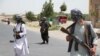 FILE - Former Mujahideen hold weapons to support Afghan forces in their fight against Taliban, on the outskirts of Herat province, Afghanistan, July 10, 2021. 