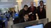 Executive Chairman of Google, Eric Schmidt (C) and former New Mexico governor Bill Richardson (2nd R) watch as a North Korean student surfs the Internet at a computer lab during a tour of Kim Il Sung University in Pyongyang, January 8, 2013. 