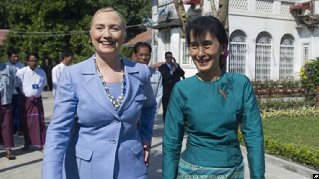 Burma's pro-democracy opposition leader Aung San Suu Kyi, right, and U.S. Secretary of State Hillary Rodham Clinton tour the grounds after meetings at Suu Kyi's residence in Rangoon, Burma December 2, 2011.