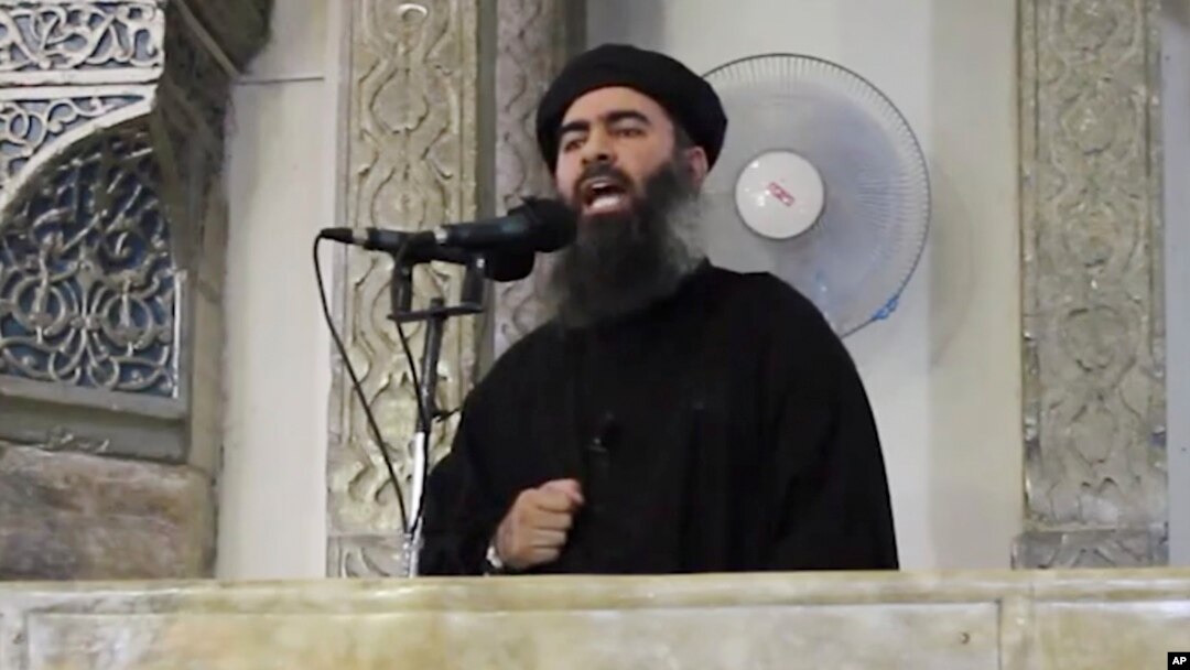 FILE - This image from video posted in July purports to show Islamic State leader Abu Bakr al-Baghdadi delivering a sermon in Iraq.