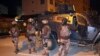Turkish anti-terrorism police stand by their armoured vehicle during an operation to arrest people over alleged links to the Islamic State group, in Adiyaman, southeastern Turkey, early Sunday, Feb. 5, 2017. 