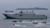 FILE - Royal Australian Navy HMAS Adelaide cruises alongside landing crafts with Philippine Marines and Australian troops as they conduct a joint Humanitarian Aid and Disaster Relief (HADR) exercise off Subic Bay in northwestern Philippines. 