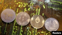 FILE - Representations of the Ripple, Bitcoin, Etherum and Litecoin virtual currencies, Feb. 13, 2018.