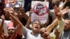 Egyptian protesters shout anti-Muslim Brotherhood slogans as they hold posters depicting President Mohammed Morsi during a protest in Tahrir Square in Cairo, Egypt, June 28, 2013.