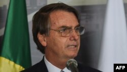Brazil's President Jair Bolsonaro delivers a speech in Itaipu, Paraguay, Feb. 26, 2019.