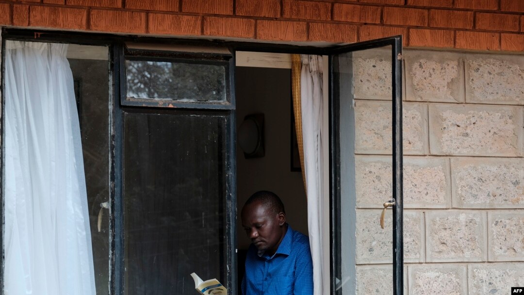 A man reads a book to pass the time at a government designated quarantine facility in Nairobi on April 4, 2020.