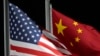 FILE - The American and Chinese flags wave at Genting Snow Park ahead of the 2022 Winter Olympics, in Zhangjiakou, Feb. 2, 2022. The Chinese government placed sanctions on seven companies on Friday in response to recent US announcements of military sales and aid to Taiwan