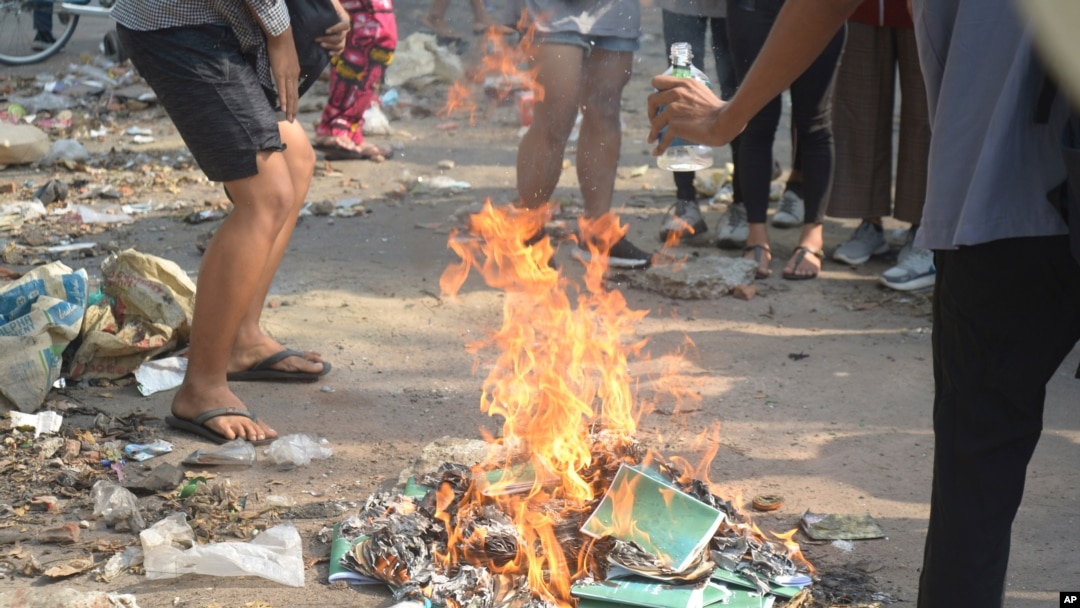 Anti-coup protesters burn constitution books at Tarmwe township in Yangon, Myanmar, April 1, 2021.