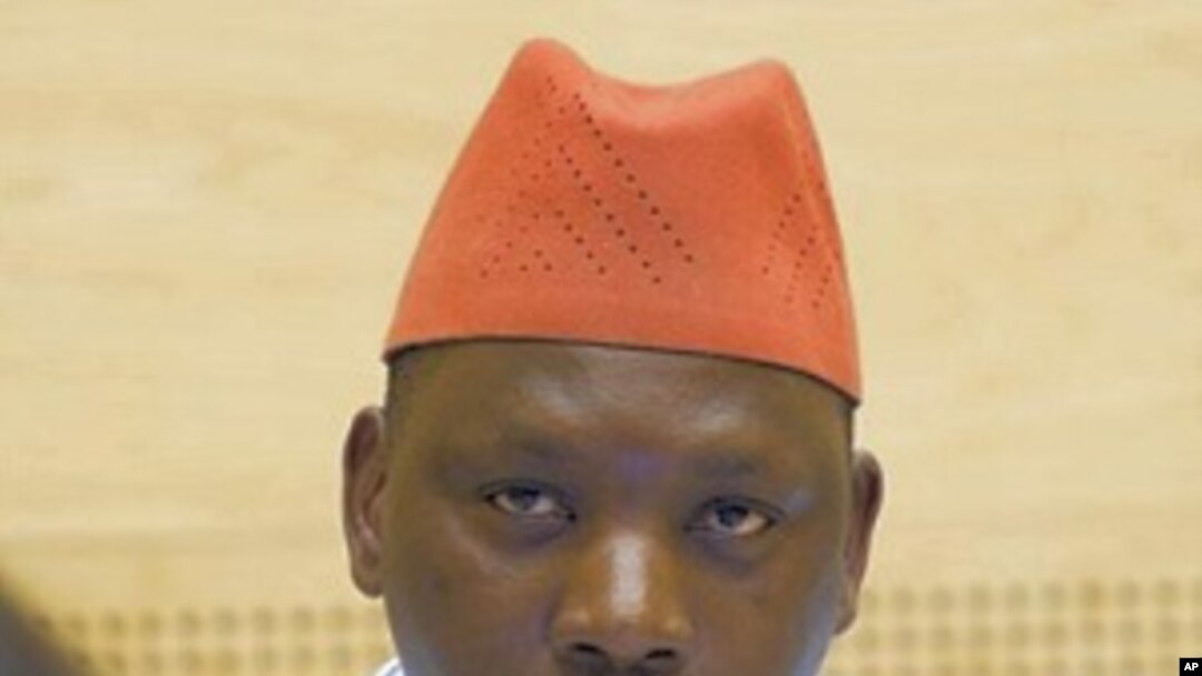 Thomas Lubanga, an alleged Congolese warlord, looks up from behind a computer screen as he waits for the International Criminal Court to announce whether it will halt the court's first trial and release the defendant, in The Hague, Netherlands, 8 Oct. 201