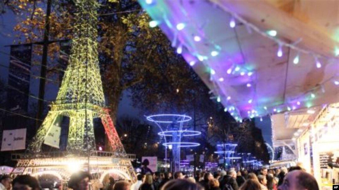 Shoppers visit the Christmas market along the Champs Elysees in Paris, December 3, 2011.