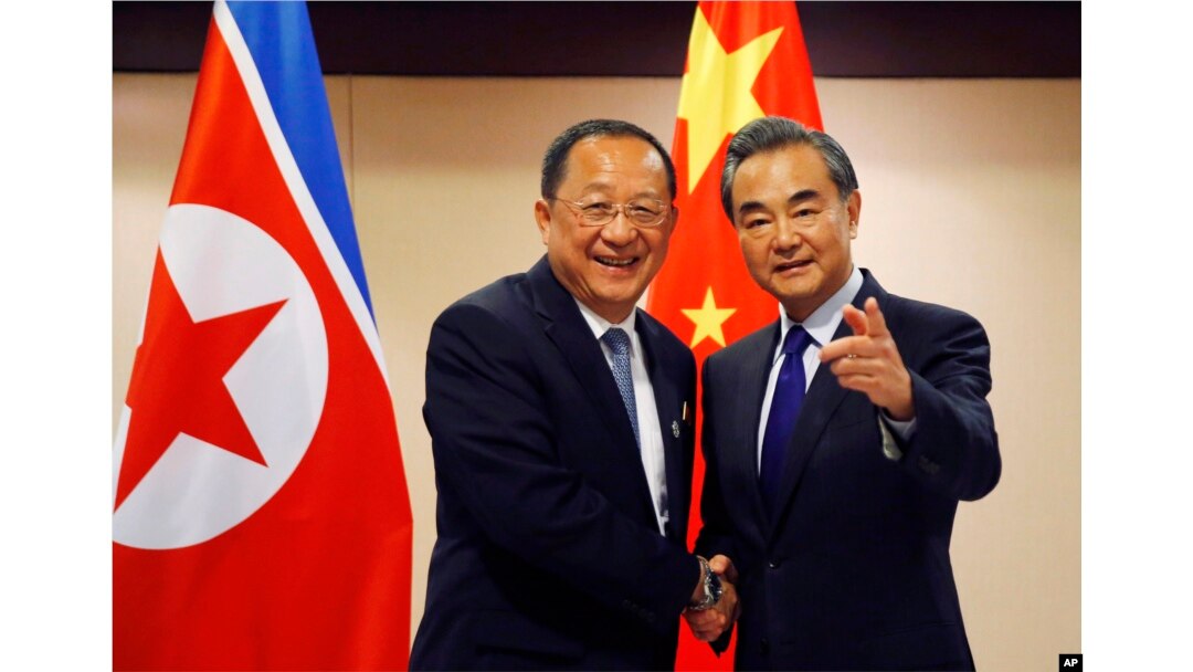 N. Korean Foreign Minister Ri Yong Ho, left, is greeted by his Chinese counterpart Wang Yi prior to their bilateral meeting on the sidelines of the 50th ASEAN Foreign Ministers' Meeting and its Dialogue Partners, Aug. 6, 2017.