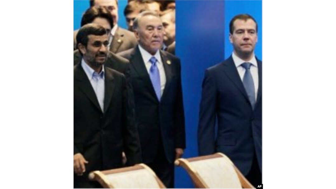 Front row from left, Iranian President Ahmadinejad, Kazakhstan's President Nazarbayev and Russian President Medvedev walk after a meeting of the Shanghai Cooperation Organization in Kazakhstan's capital Astana, June 15, 2011