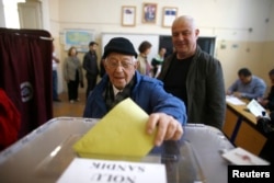 FILE - A man casts his ballot at a polling station during a referendum Aegean port city of Izmir, Turkey, April 16, 2017.