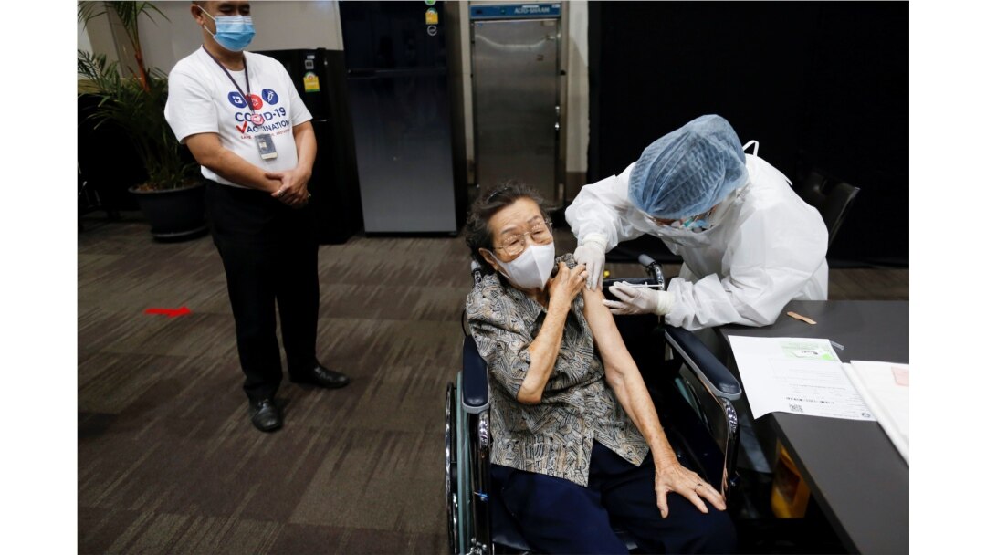 A person receives the first dose of the AstraZeneca COVID-19 vaccine as Thailand starts a mass inoculation at a gymnasium inside the Siam paragon Shopping center, Bangkok, Thailand, June 7, 2021.