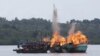 FILE - Malaysian and Vietnamese fishing boats are destroyed for illegal fishing by the Ministry of Maritime Affairs and Fisheries, police and navy, in Batam, Riau Islands, Indonesia, April 5, 2016. The Indonesian government reportedly sank 28 illegal foreign fishing boats simultaneously in nine locations across the country. 
