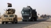 A convoy of Iraqi military vehicles heads toward Qayyarah base in northern Iraq, ahead of an expected offensive to retake Mosul from Islamic State militants, Oct. 15, 2016.