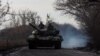 Ukrainian servicemen ride atop a tank near the front-line town of Bakhmut in Donetsk region, Jan. 20, 2023.