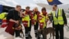 Members of Germany's NGO organization International Search and Rescue (ISAR- Germany) prepare sniffer dog Apache to board their flight to Nepal from Frankfurt airport, April 26, 2015. 